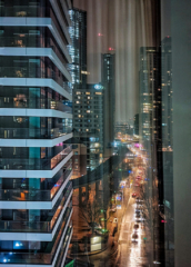 London architectural photographer david chatfields shot of buildings at night with lights of traffic and builds.