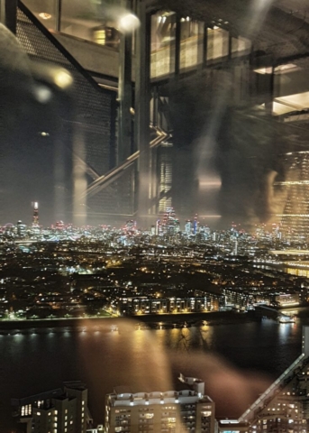 abstract image from high up over london at night from inside a hotel through glass. visable is the shard, the river thames and the city.UK Photographer | David Chatfield Photography