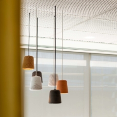 Interior photography for an office. some lights hanging from the ceiling with windows in the background