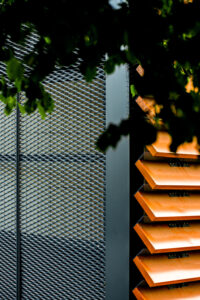 Archtectural detail with metal and wood with overhanging tree