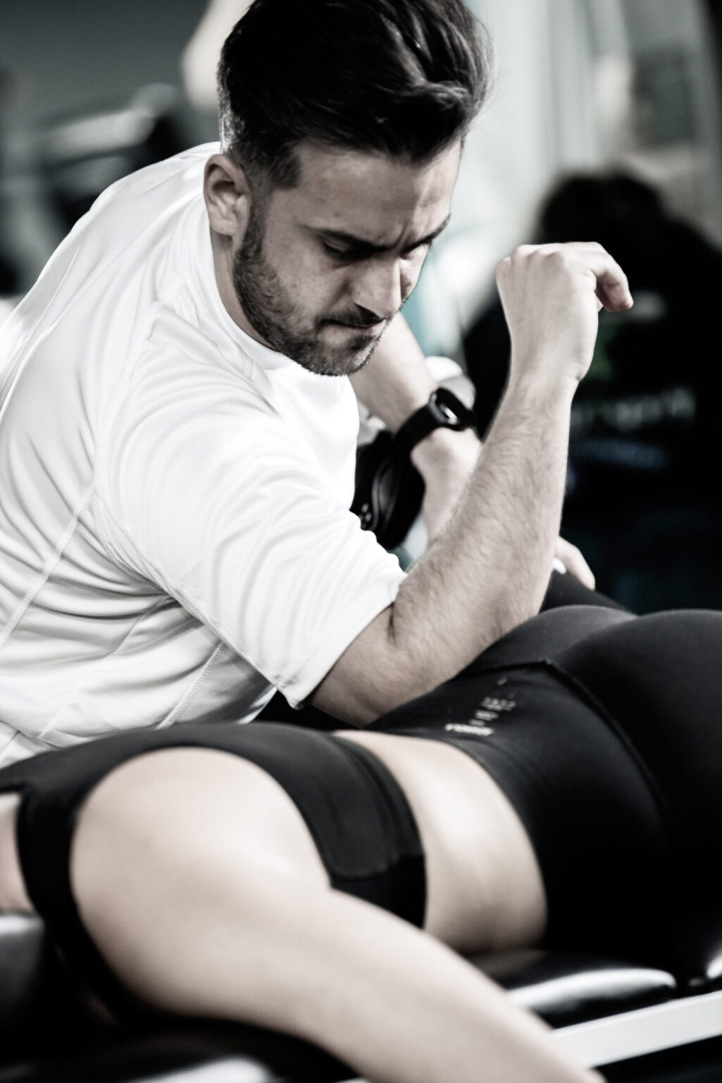 masseur giving sports thearapy to a female.