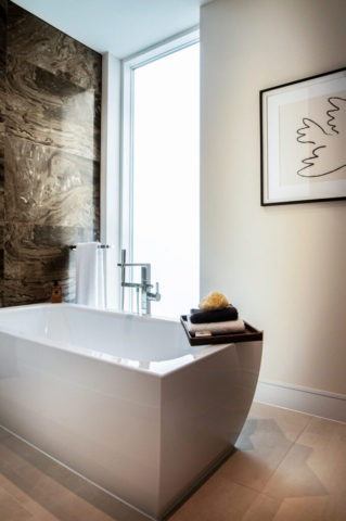 Bathroom suite Interior of owners bathroom with marblw wall, artwork and a natural stone floor. super yacht interior