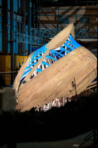 An upsidedown hull of a Q class yacht in the construction stage. lit by flash gun on the outside and inside