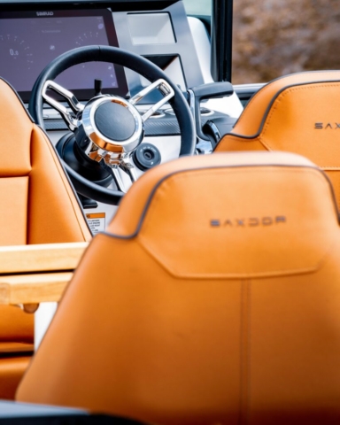 Saxdor rib A long shot of the stering wheel on the Saxdor rib with warm orange leather seats